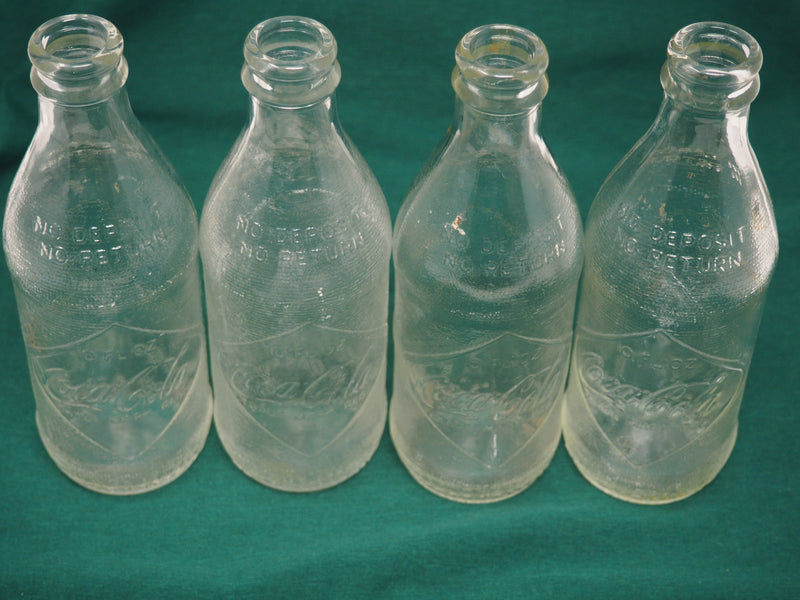 Four Vintage Coca-Cola Clear Straight Sided Bottles