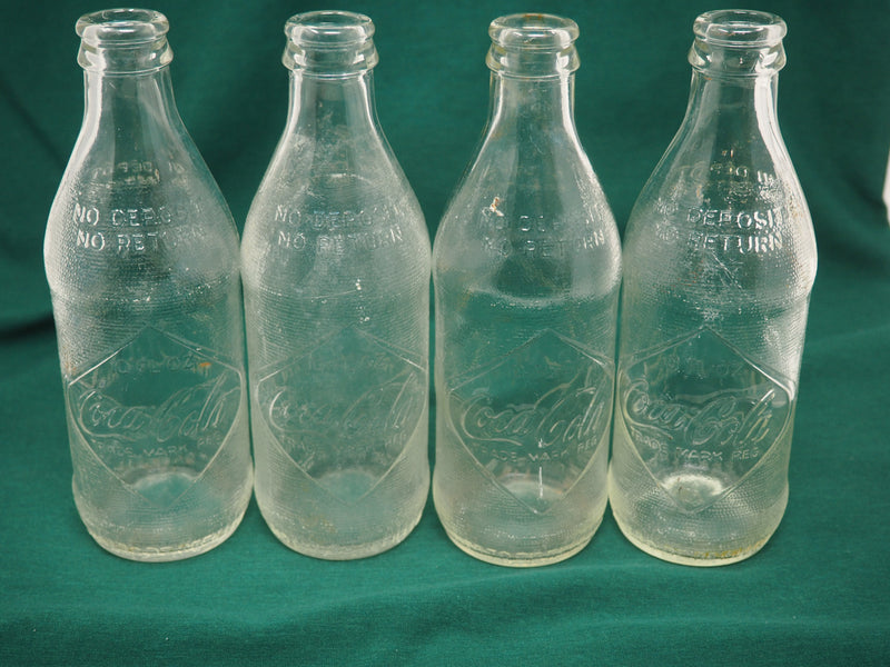 Four Vintage Coca-Cola Clear Straight Sided Bottles