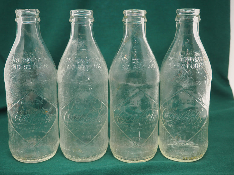 Four Vintage Coca-Cola Clear Straight Sided Bottles