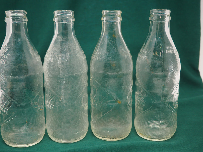 Four Vintage Coca-Cola Clear Straight Sided Bottles