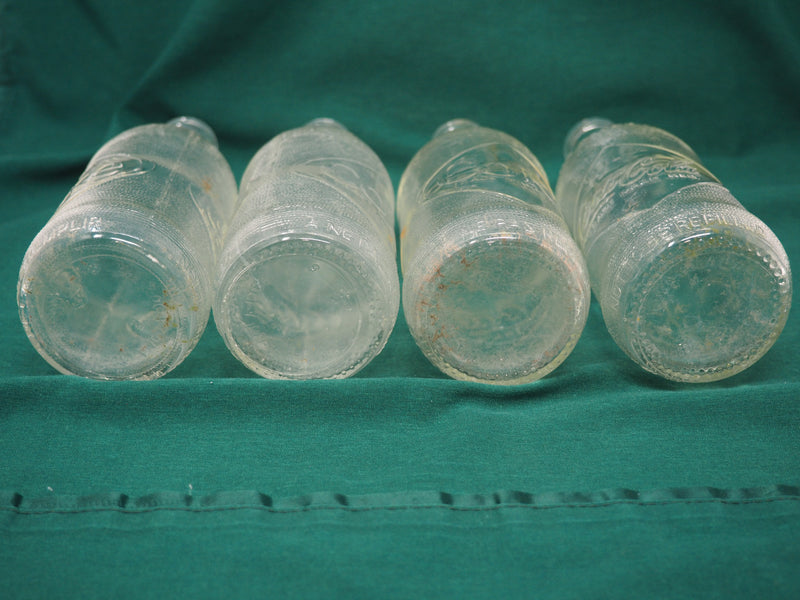 Four Vintage Coca-Cola Clear Straight Sided Bottles