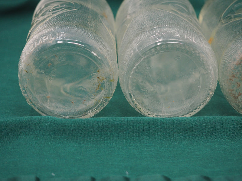 Four Vintage Coca-Cola Clear Straight Sided Bottles