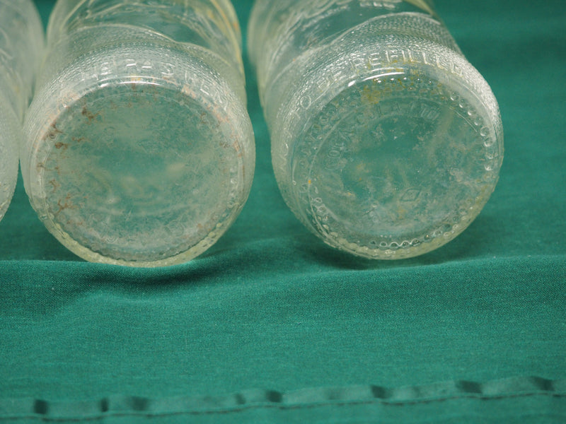 Four Vintage Coca-Cola Clear Straight Sided Bottles