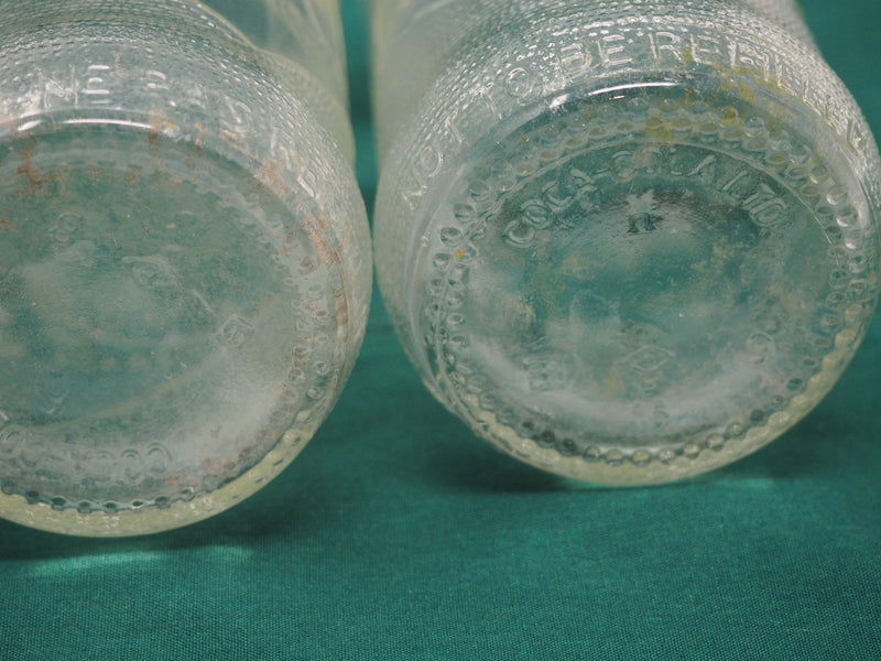 Four Vintage Coca-Cola Clear Straight Sided Bottles