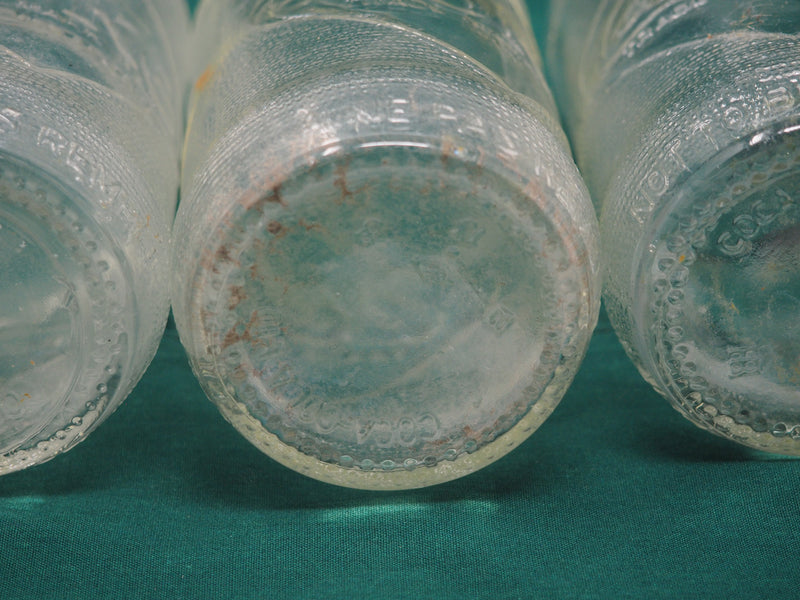 Four Vintage Coca-Cola Clear Straight Sided Bottles